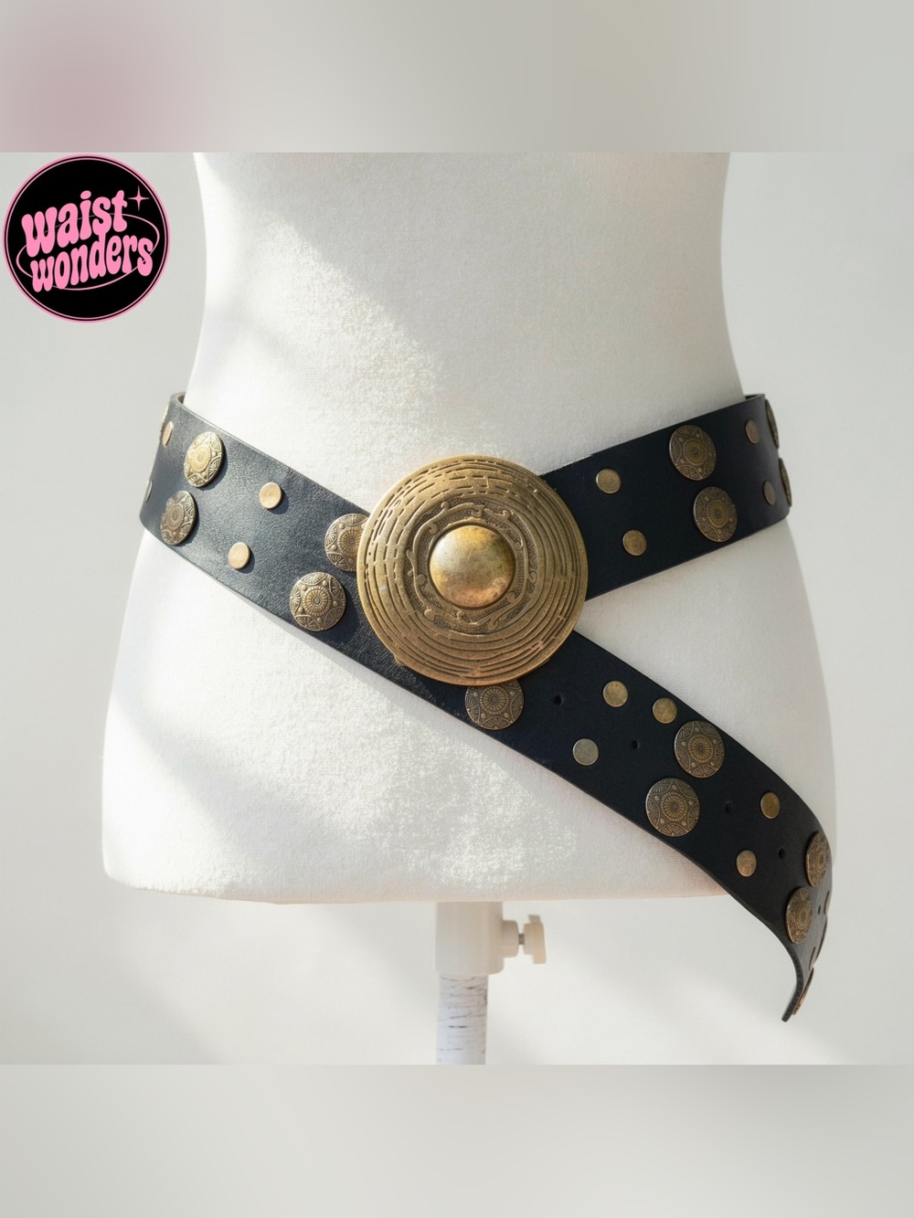 Y2K 2000s style Black leather belt with gold circular studs and a large central